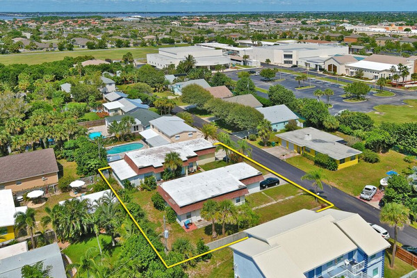 Aerial view of two duplexes side by side by the road