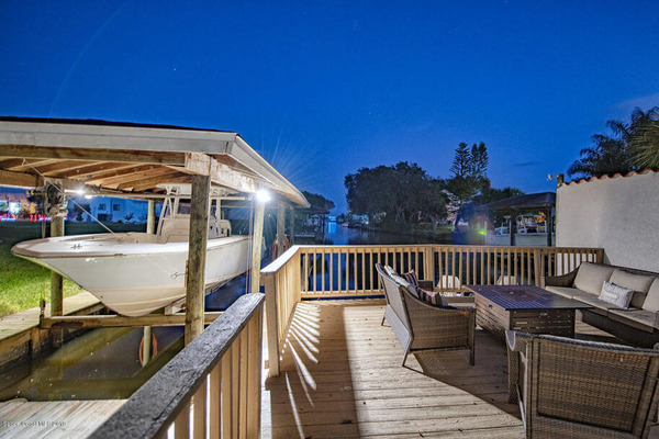 dock with table and chairs and attached boat lift at night 