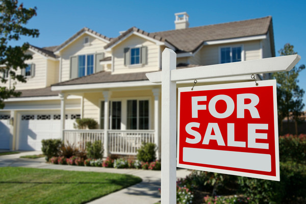 for sale sign in front of pale yellow home with front porch