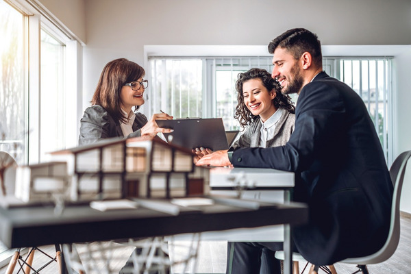 couple discuss investment property with advisor