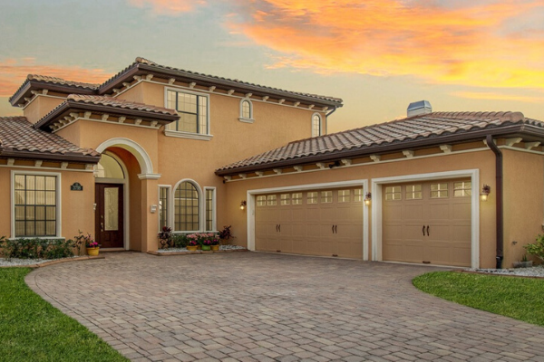 Driveway and garage of home in Brevard County with sunset