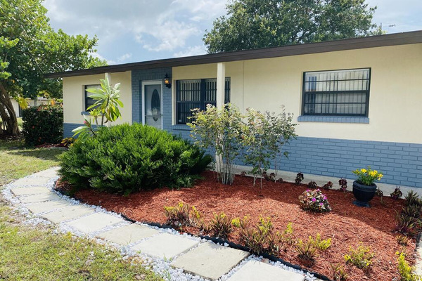 front walkway of single story home with blue brick details 