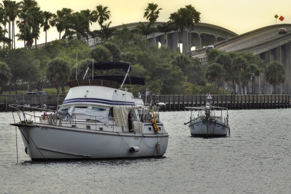 yacht anchored at the Merritt Island Bridge with palm trees 