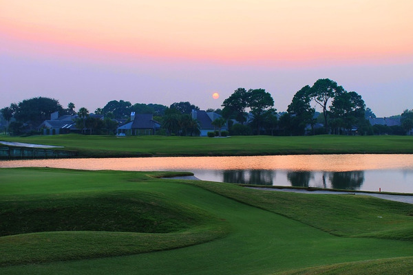 sunset over golf course water feature