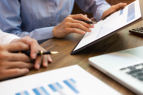 closeup of two people reviewing marketing strategy