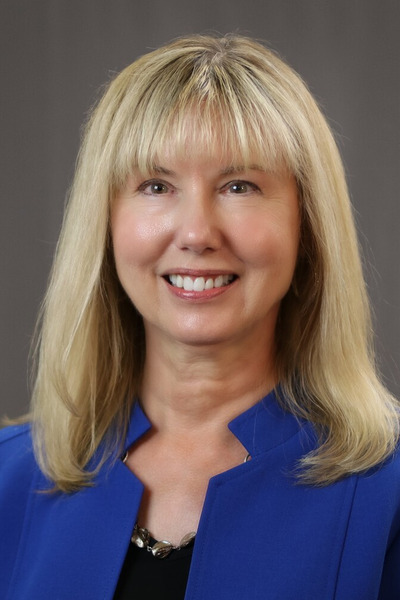 Lynn Congdon headshot with royal purple jacket & black top