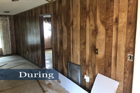 This image shows the living area after the carpet and baseboards were removed.