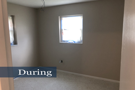 Bedroom #4 during renovation after wall color was applied.  