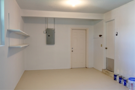 Opposite end of renovated garage is in keeping with the light, bright renovated interior