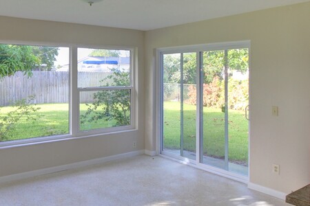 Dining area after renovation.  Tons of light from windows and sliders illuminate the space and show-off the views outside