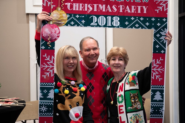 Three Ellingson Properties team members in ugly Christmas sweaters