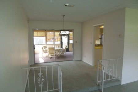 Before - Dinning Room is a step up from living room with railing & gate delineating the room.