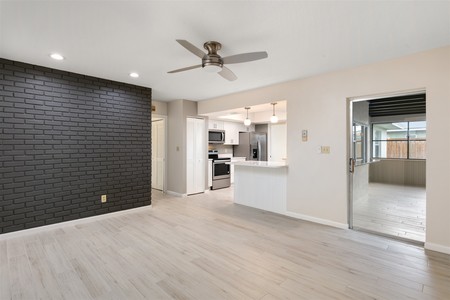 After - Brick accent wall painted darker provides focal point.  Breakfast bar re configured with added bead board detail and elimination of flooring changes.