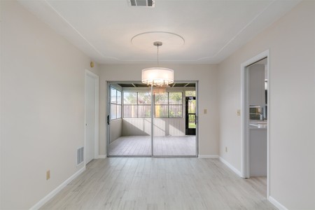 After - Lighter vinyl plank flooring, wall color and contemporary light fixture make all the difference