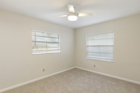 After - Ceiling fan with light, new paint and fresh carpet make the difference in Bedroom 3