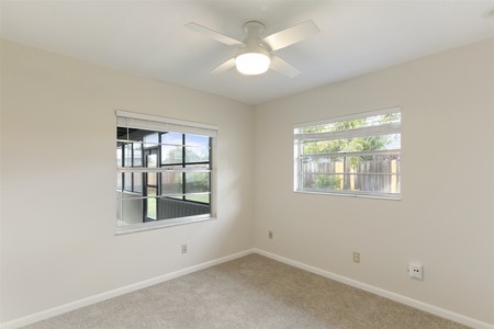 After - Carpet, paint and a ceiling fan was all it took to update Bedroom 2