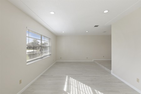 After - Popcorn ceiling removed and textured ceiling added. Recessed lights better illuminate the room.  Durable and beautiful vinyl plank replaces carpet in high traffic areas