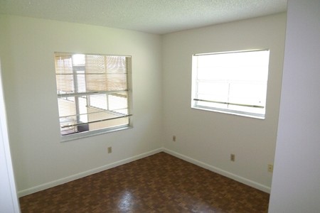 Before - Bedroom 2 yellow walls and dark parquet flooring looked tired