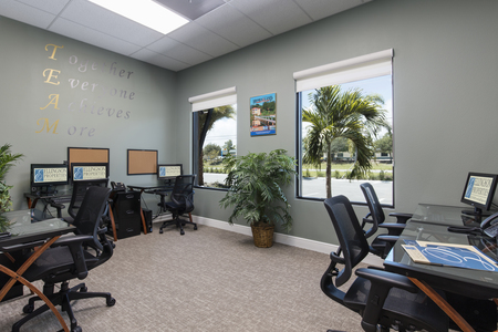 Multi-Agent bullpen houses six desks and is bathed with light from two west facing windows