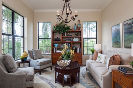 An array of windows bathe the study with natural light. There is plenty of room for a couch and chairs