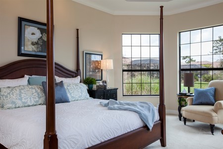 A large master suite with bay windows overlooking the preserve