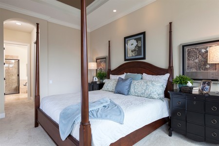 Tray ceilings and crown molding dress up the master bedroom