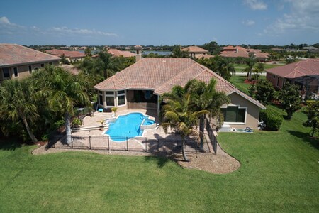 Aerial of Backyard prior to expansion project shows plain paver deck around pool.