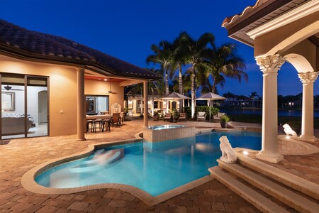 Another twilight view looking from the pergola, over the pool to the summer kitchen.