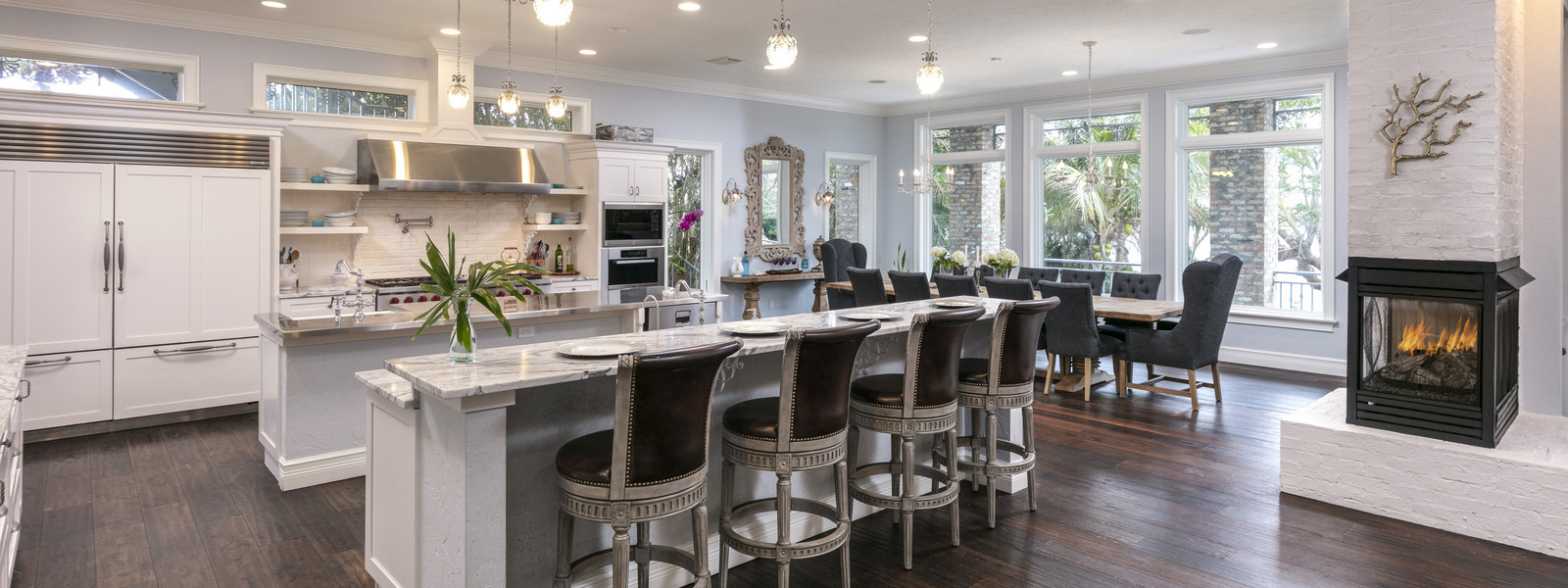 stunning two island kitchen with dining table in background